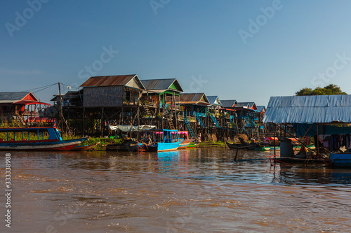 Kampong Phluk Floating Village on the Tonle Sap lake near Siem Reap, Cambodia during sunset. The Stilt houses of the floating town during low tide. Exotic places at South East Asia