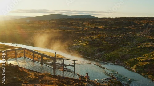 A Wooden Footbridge And The Boiling Water With Steam From The River Found In Reykjavik, Iceland photo