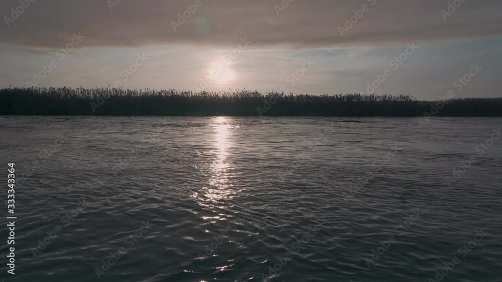 Beautiful sunset over the river and fishing rod