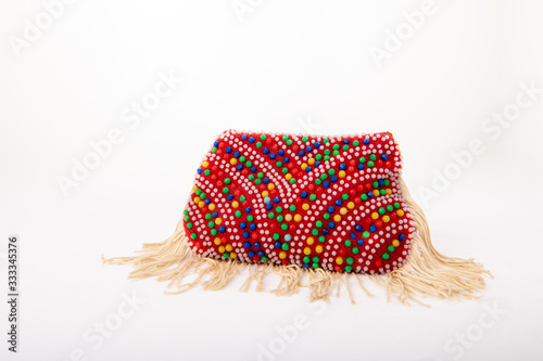 Close up of a vintage coin purse, made from beads. It has tassles and a retro style from the 1970s.