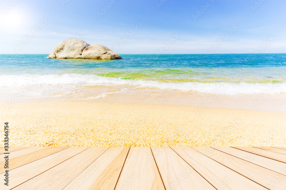 beach and sea with wooden desk for take products on