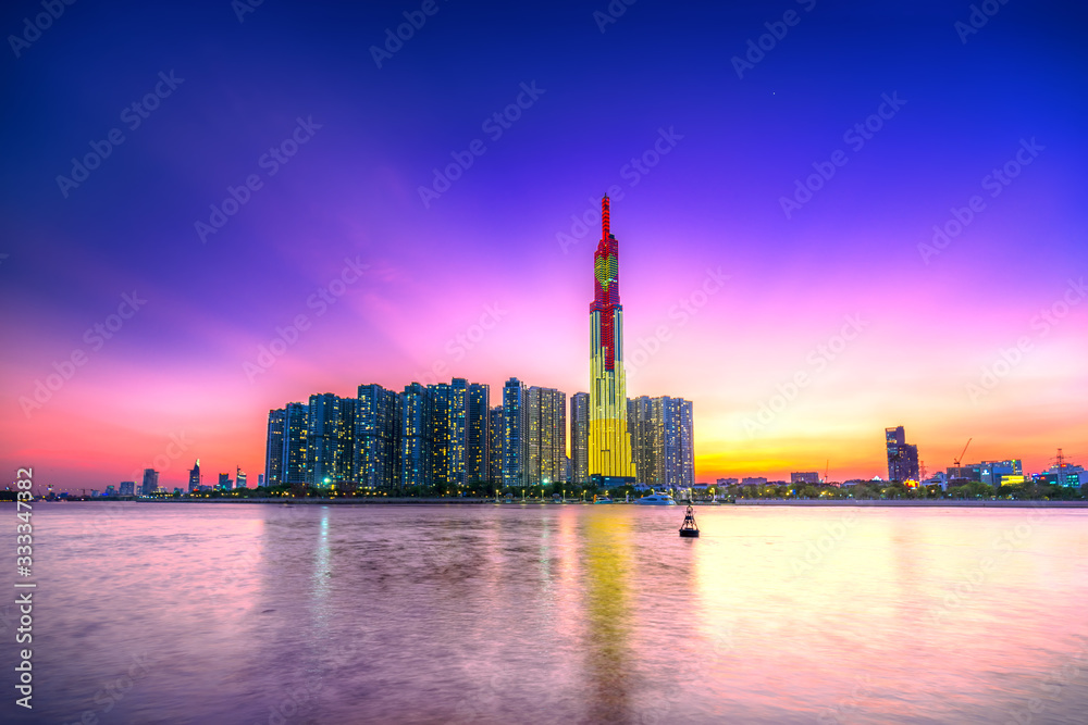 Colorful sunset landscape in a riverside urban area with skyscrapers showing the most economic development in Ho Chi Minh City, Vietnam