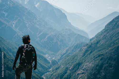 Man enjoys the perfect nature view of the mountains in Nepal, Himalayas.