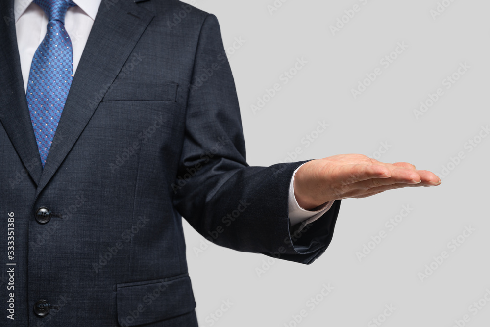A businessman holding his palm. With copy space. A businessman holding his palm. With copy space.