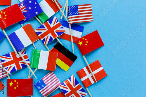 Mini flags of USA, France, Germany, Italy, Great Britain, Holland on blue background © Natali