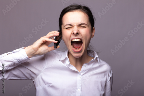girl in a white shirt communicates on the phone