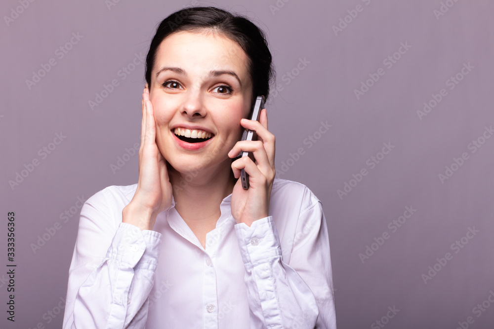 girl in a white shirt communicates on the phone