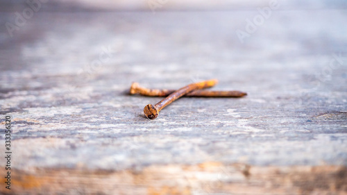 close up rusty curved nails wintage wooden plank texture background