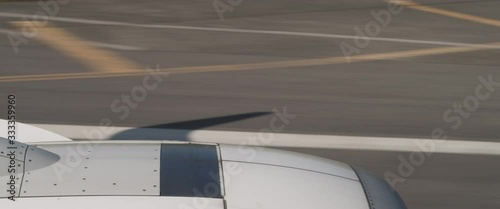 Plane taking off the runway with the shadow of the wing, view from the inside of a plane. Aircraft moving very fast on the runway. Adventure, travel, journey concept. BMPCC 4K