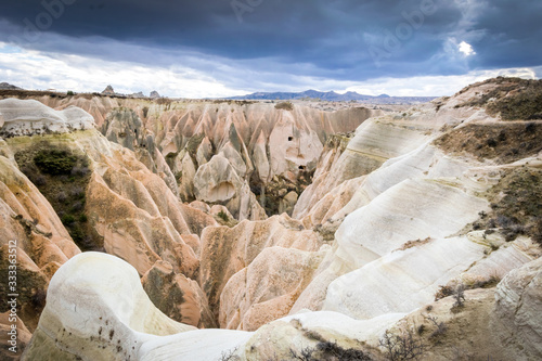 Rocky landscape of Rose valley with many colorful taxtures in a cloudy day with no people. Geological formations of Cappadocia. Stunning landscapes in Turkey. photo