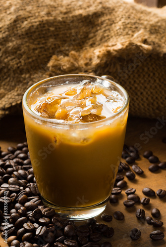 cup of coffee and coffee bean wooden table