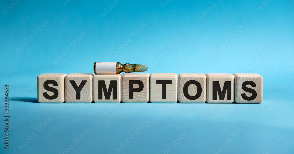 SYMPTOMS - word on cubes. Drug in ambula to reduce disease symptoms on a blue background