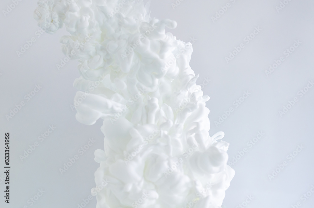 Blurred and focus white poster color dissolving in water for abstract and backgorund concept. Blurred and focus white poster color dissolving in water for abstract and backgorund concept.