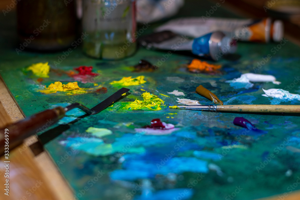 oil paints, paintbrush and palette knife on the palette closeup oil paints, paintbrush and palette knife on the palette closeup