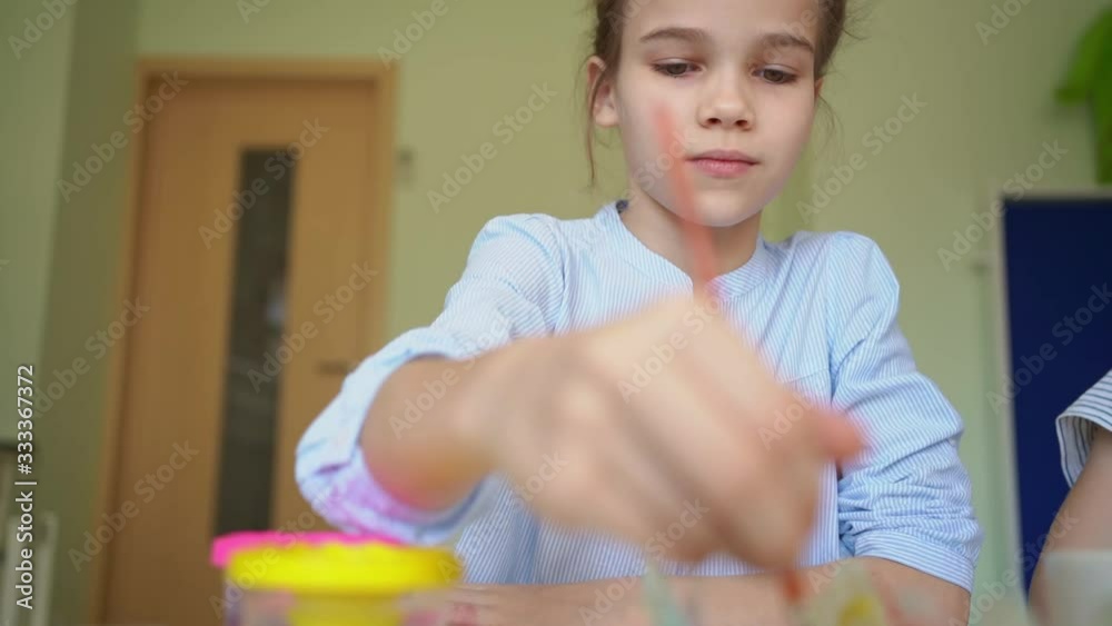 kid drawing with brush and paints kid drawing with brush and paints