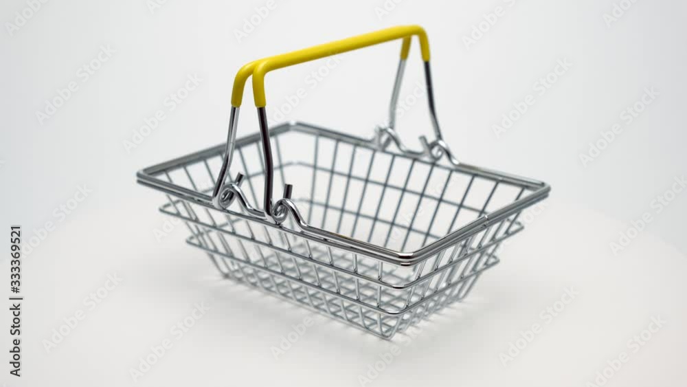 The basket rotates 360. Shiny with yellow handles on a white background. The basket rotates 360. Shiny with yellow handles on a white background.