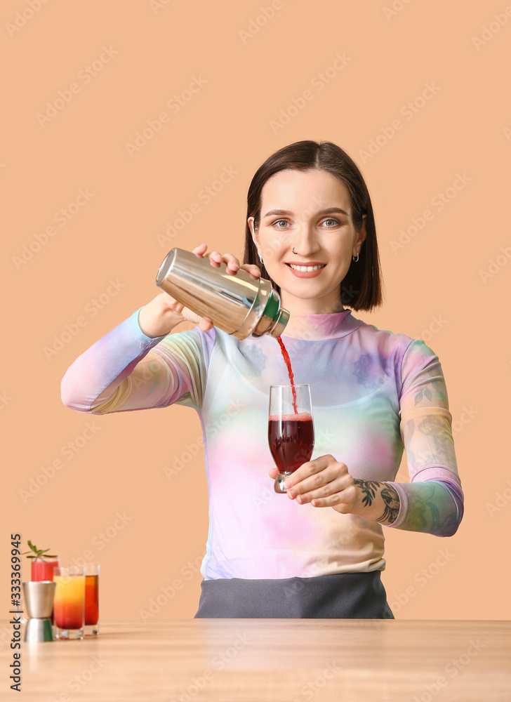 Female bartender at table against color background Female bartender at table against color background