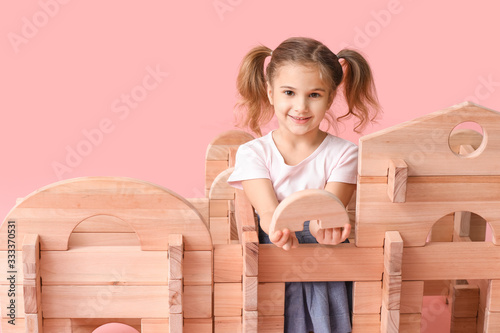 Little girl playing with ta...