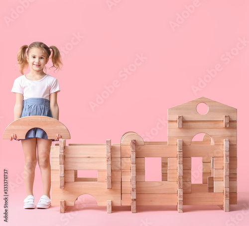 Little girl playing with ta...