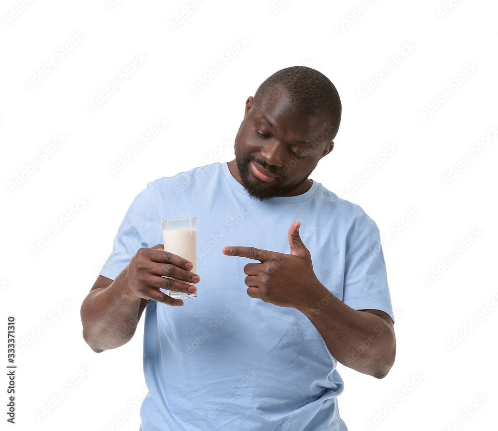 African-American man with milk on white background