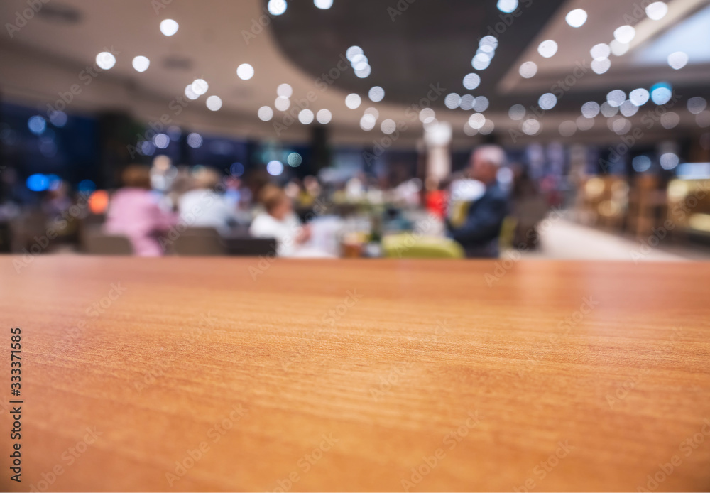 Table top wooden counter Blur interior shop cafe restaurant with people sitting background Table top wooden counter Blur interior shop cafe restaurant with people sitting background
