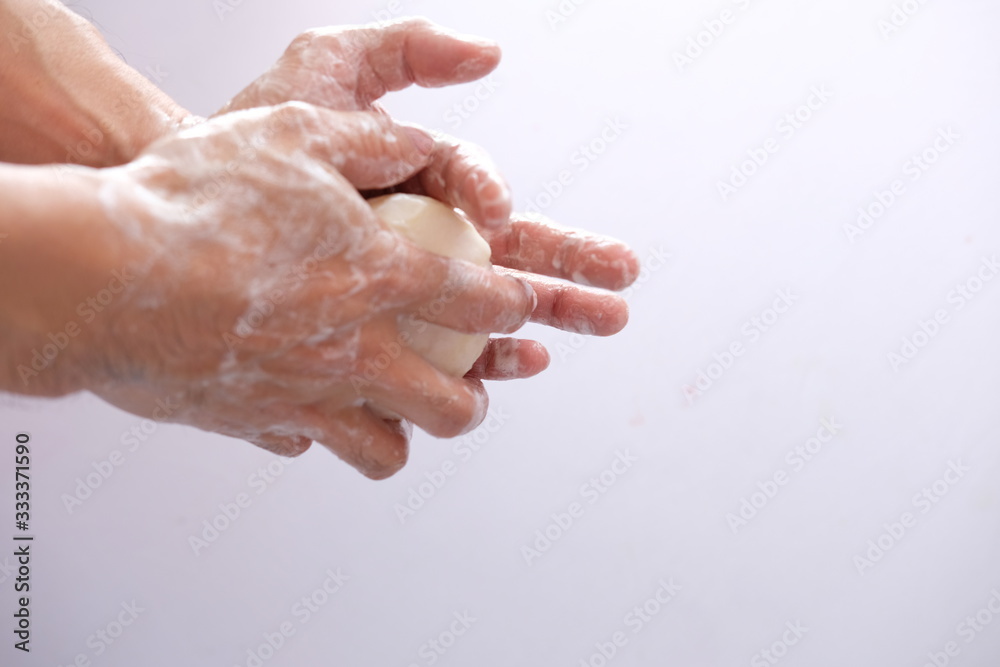 Fototapeta premium washing hands with liquid soap and sponge