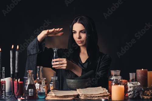 Female alchemist making pot...