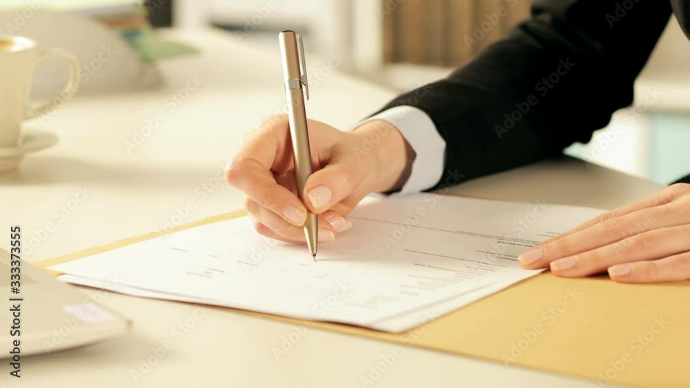 Executive hands filling out form at office