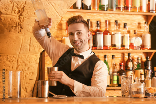 Male bartender making cockt...