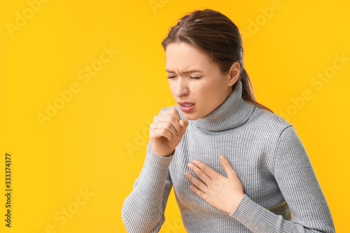 Fotografie, Obraz Ill coughing young woman on color background