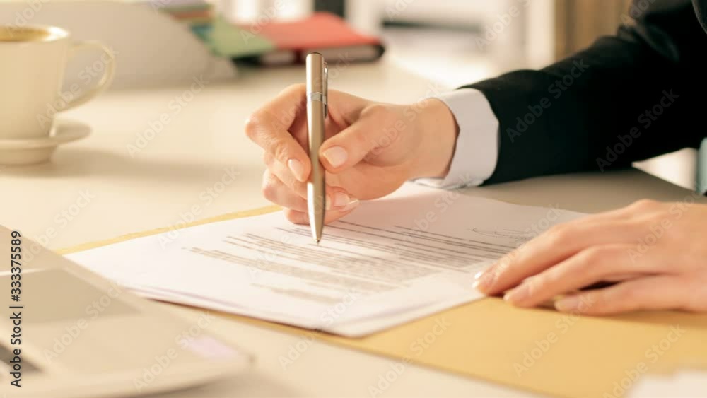 Executive hands checking and signing contract at office