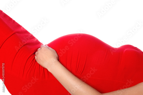 Happy pregnant girl lies on a white background. Medicine for women with a child in the stomach. © Kostia