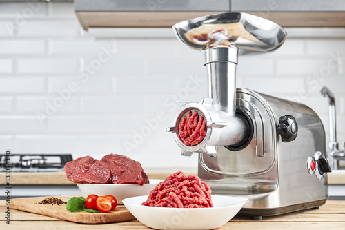Fotótapéta Bowl of mince with electric meat grinder in kitchen interior