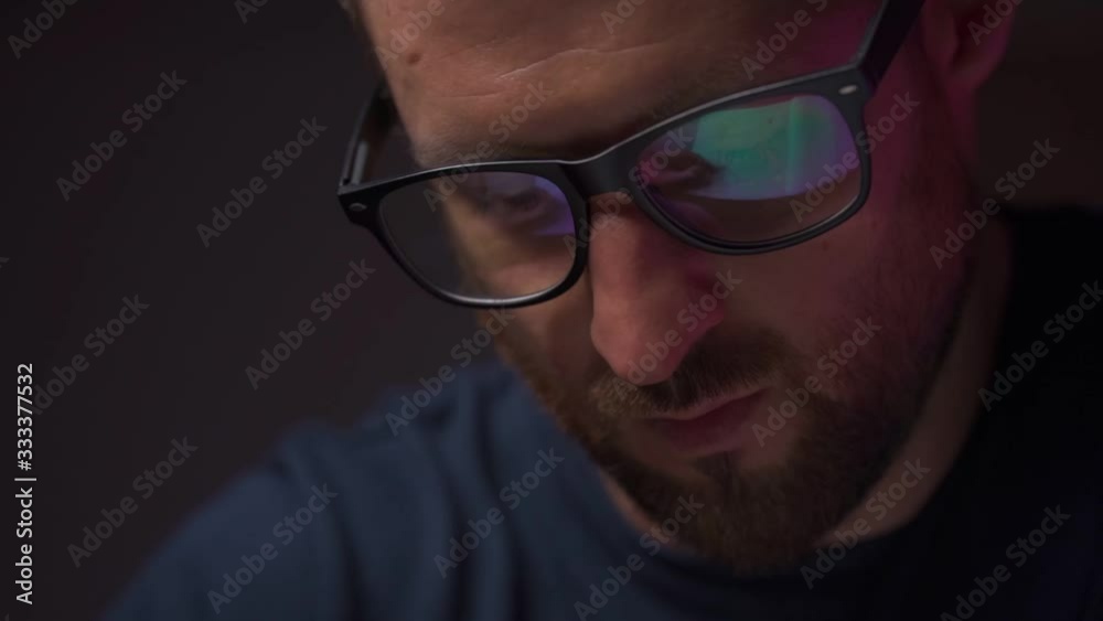 Reflection in Men's Glasses. Office routine, a man writes in slow motion Reflection in Men's Glasses. Office routine, a man writes in slow motion