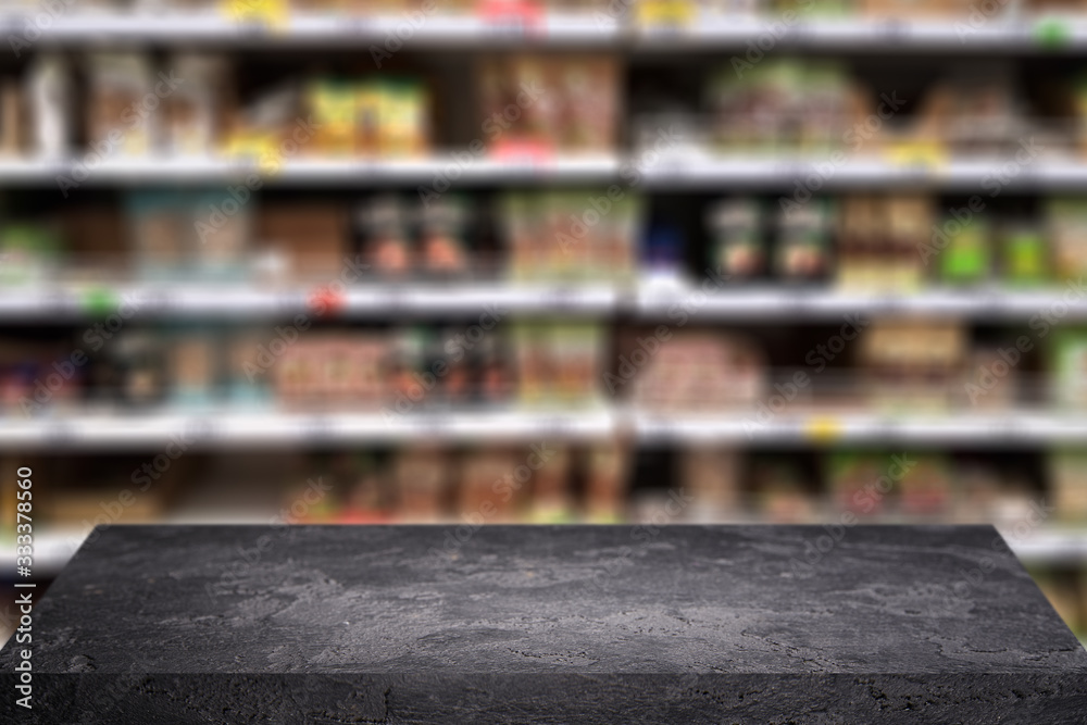 Black stone surface on blurry background at grocery store. - obrazy, fototapety, plakaty 