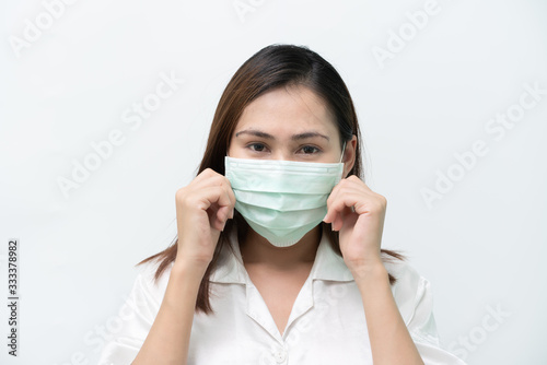 White shirts wearing medical masks to prevent the flu and the Covid-19 Corona virus and carrying a mask.
