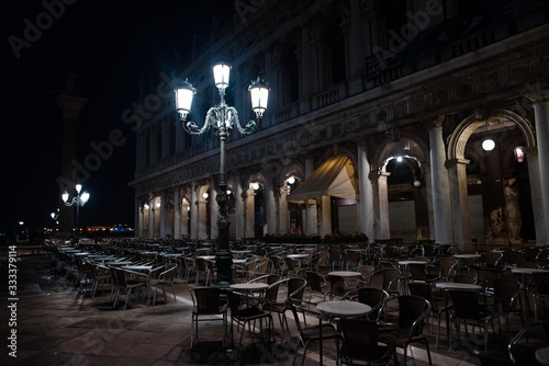 Empty big street cafe at night, lit by lanterns. Night Venice, Italy