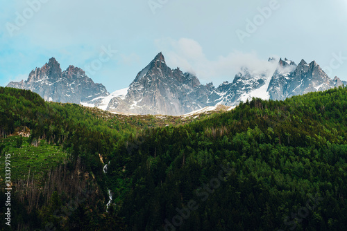 View of forest and sharp rocks with snow. Mountain landscapes in Alps, France