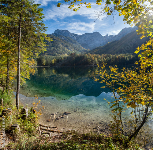 Peaceful autumn Alps mountain lake with clear transparent water and reflections. Langbathseen lake, Upper Austria. photo