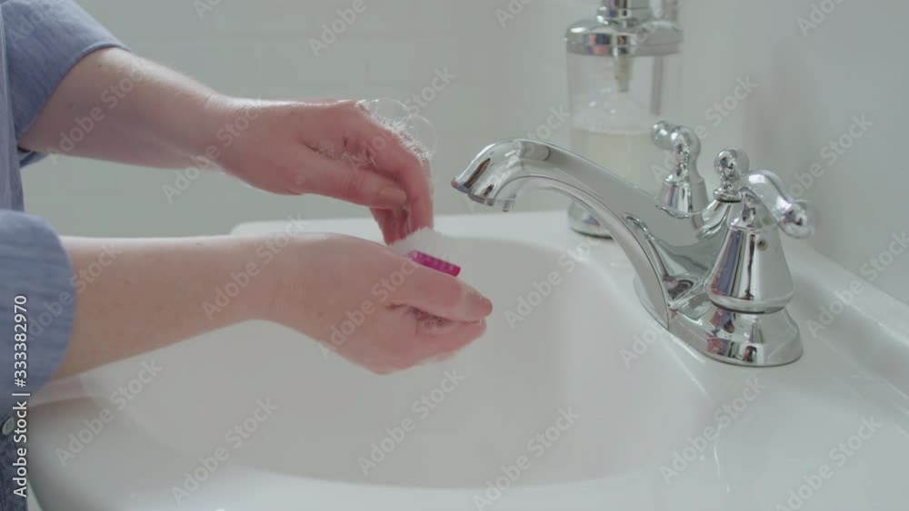 Closeup Of Woman Using Nail Brush To Thoroughly Clean Her Fingernails In Sink Closeup Of Woman Using Nail Brush To Thoroughly Clean Her Fingernails In Sink