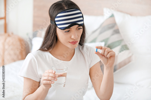 Young woman taking pills fo...