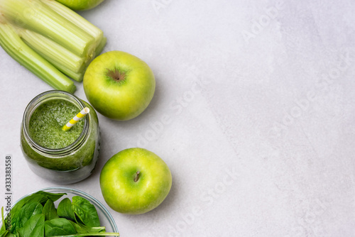 Glass Jar of Healthy Green Smoothie Detox Drink wirh Green Apple Celery and Raw Spinach Diet Beverage TopView Flat Lay