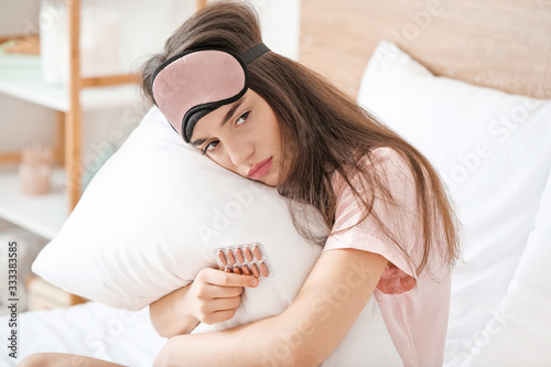 Sad woman with pills for in...