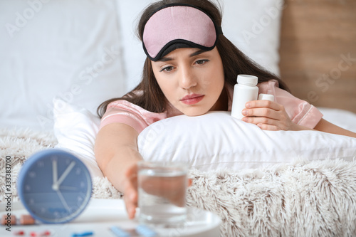 Tired woman with pills for ...