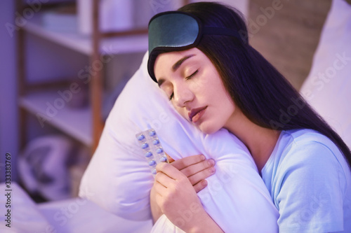 Tired woman with pills for ...