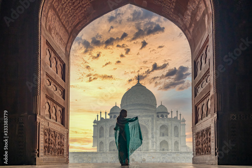 Canvas Print Woman in traditonal culture dress saree or sari in the Taj Mahal, Taj Mahal is most beautiful white marble mausoleum in the Indian city, Agra, Uttar Pradesh, India