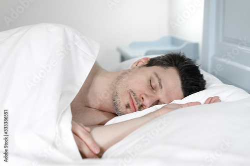 young man sleeping in bed