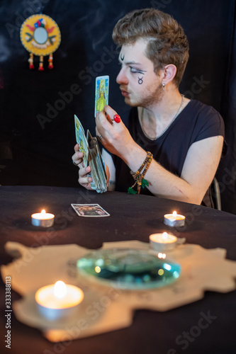 Fortune teller using tarot cards on black background