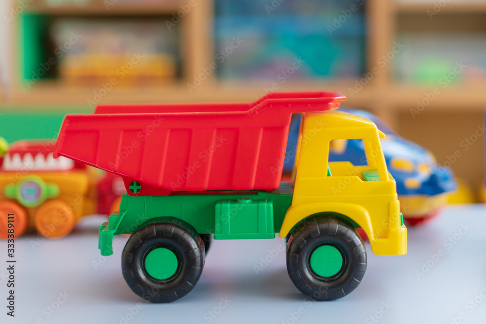 plastic toys are on the table of the car.educational toy constructor stands on a table in a kindergarten or at home plastic toys are on the table of the car.educational toy constructor stands on a table in a kindergarten or at home