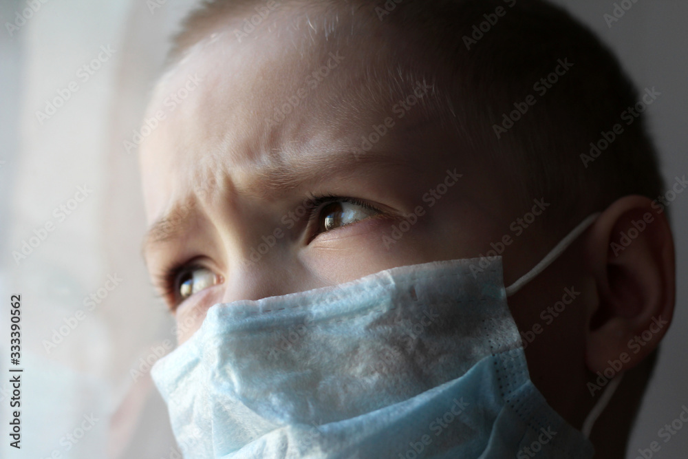 Toddler boy with a medical mask on his face Warning of the dangers of traveling to China and safety measures against coronavirus 2019 nKoV Coronavirus originating in Wuhan, China Close-up portrait Toddler boy with a medical mask on his face Warning of the dangers of traveling to China and safety measures against coronavirus 2019 nKoV Coronavirus originating in Wuhan, China Close-up portrait